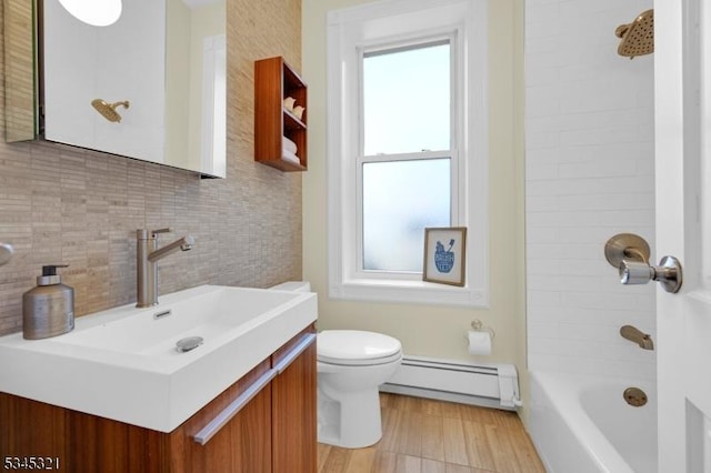 bathroom featuring a baseboard radiator, tasteful backsplash, toilet, shower / bathtub combination, and vanity