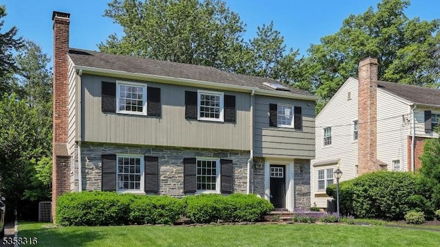 126 Wells St, Westfield Town, NJ 07090 - colonial home featuring stone siding, a front lawn, and a chimney