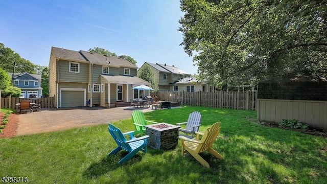 126 Wells St, Westfield Town, NJ 07090 - back of property featuring a fire pit, driveway, a garage, and a patio area