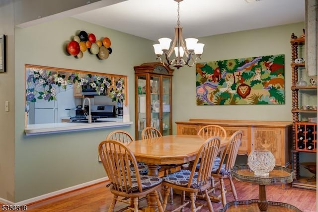 79 Boulder Run Rd, Paterson City, NJ 07501 - dining space featuring wood finished floors, a chandelier, and baseboards
