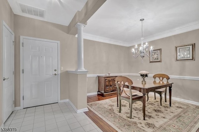 2303 Ambassador Ct Unit 2303, Franklin Twp, NJ 08873 - dining area featuring decorative columns, light tile patterned flooring, a chandelier, and ornamental molding