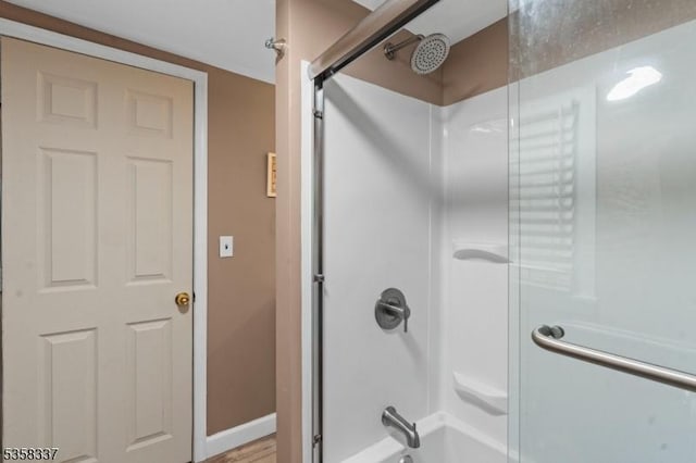 full bath with bathing tub / shower combination and baseboards