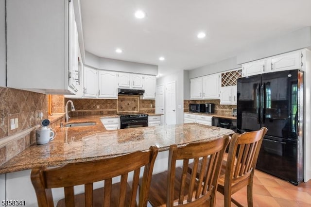45 Wagner Ln, Hillsborough Twp, NJ 08844 - kitchen with black appliances, a sink, a peninsula, light stone counters, and recessed lighting