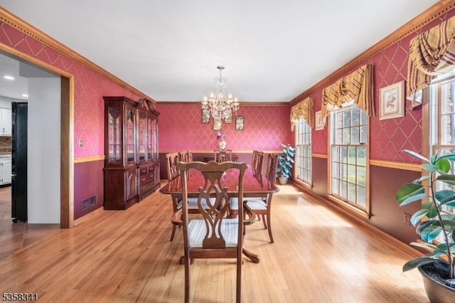 45 Wagner Ln, Hillsborough Twp, NJ 08844 - dining space featuring wallpapered walls, wood finished floors, crown molding, a chandelier, and baseboards