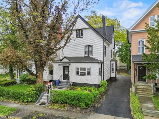 104 Hollywood Ave, East Orange City, NJ 07018 - view of front of property with a chimney, driveway, entry steps, and roof with shingles