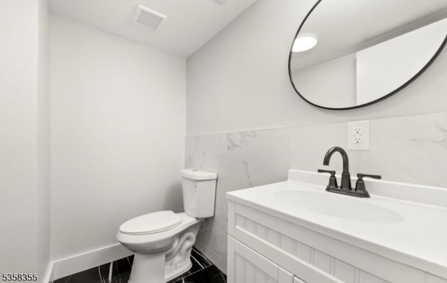 104 Hollywood Ave, East Orange City, NJ 07018 - bathroom featuring toilet, tile walls, vanity, and a wainscoted wall