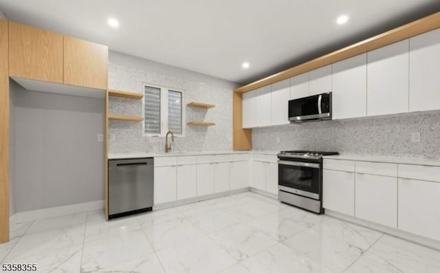 104 Hollywood Ave, East Orange City, NJ 07018 - kitchen featuring stainless steel appliances, light countertops, open shelves, backsplash, and a sink