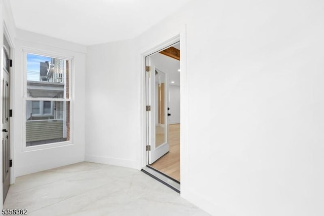 spare room with baseboards