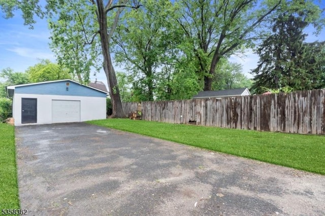 detached garage with asphalt driveway