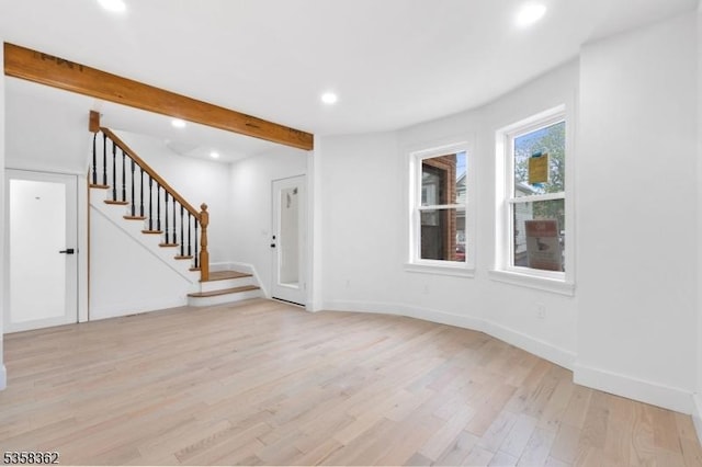unfurnished living room with light wood-style flooring, stairs, recessed lighting, and baseboards