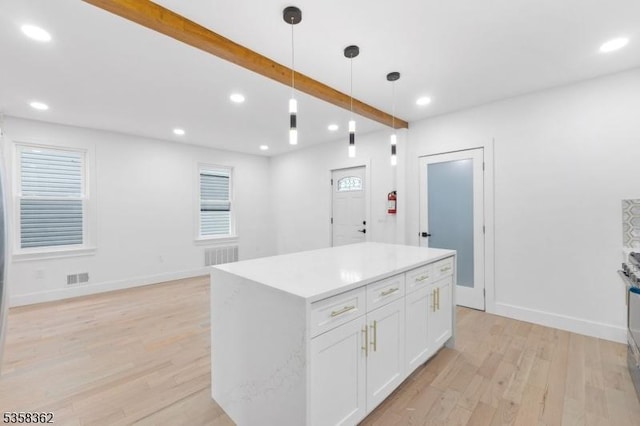 kitchen with light wood-style floors, white cabinets, a kitchen island, decorative light fixtures, and recessed lighting
