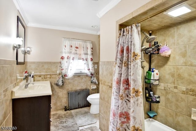 bathroom with radiator heating unit, toilet, tile walls, crown molding, and vanity