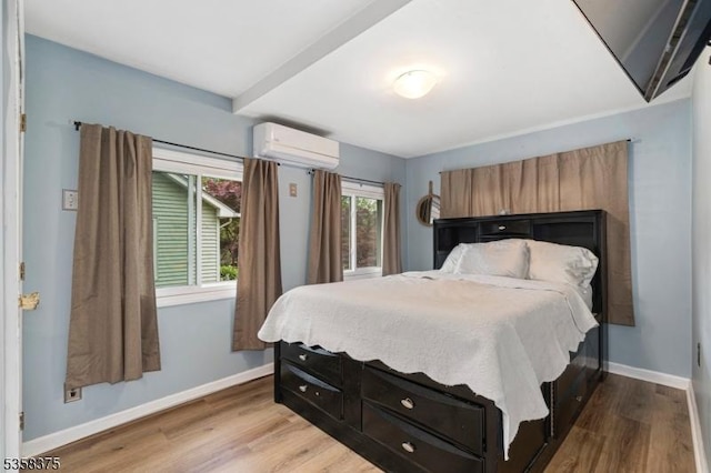 125 Schwarz Blvd, Jefferson Twp, NJ 07849 - bedroom featuring an AC wall unit, wood finished floors, and baseboards