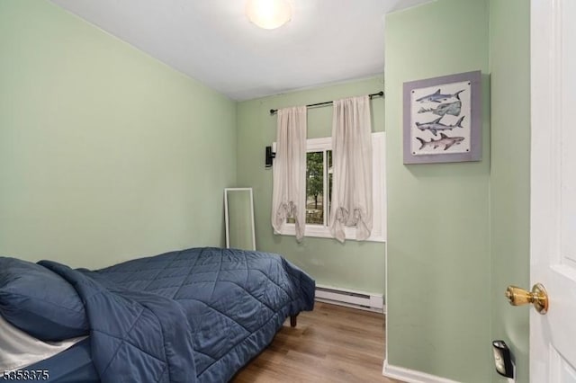 125 Schwarz Blvd, Jefferson Twp, NJ 07849 - bedroom featuring baseboard heating, wood finished floors, and baseboards