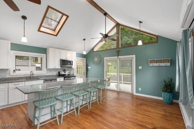 125 Schwarz Blvd, Jefferson Twp, NJ 07849 - kitchen featuring ceiling fan, stainless steel appliances, a sink, decorative backsplash, and beam ceiling