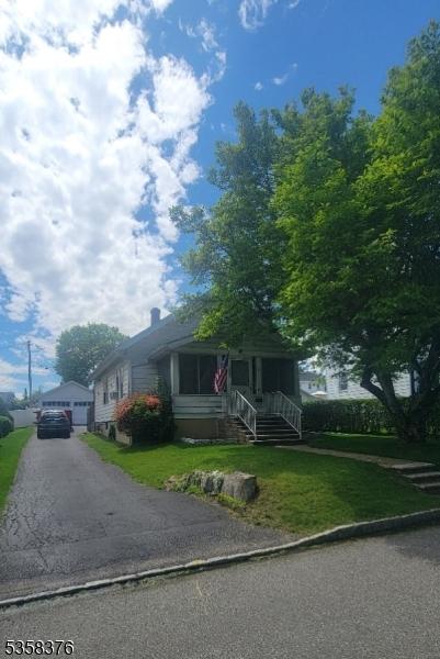 15 Fairfield Ave, Mine Hill Twp, NJ 07801 - view of front of home featuring a front yard, covered porch, and a garage