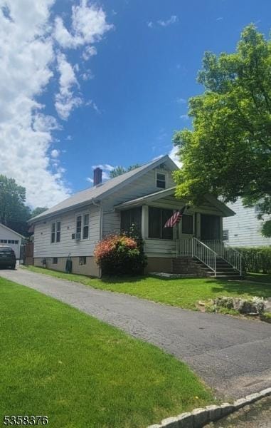 15 Fairfield Ave, Mine Hill Twp, NJ 07801 - view of front facade with a front yard, a chimney, and an outbuilding
