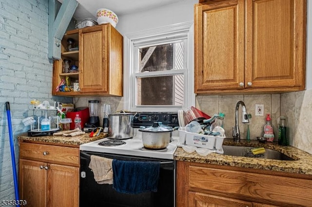 316-318 John St, Elizabeth City, NJ 07202 - kitchen featuring range with electric stovetop, a sink, tasteful backsplash, brown cabinetry, and brick wall