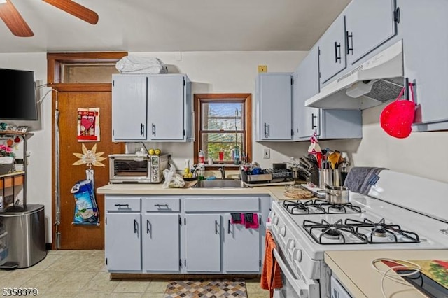 316-318 John St, Elizabeth City, NJ 07202 - kitchen featuring under cabinet range hood, gas range gas stove, a sink, and light countertops