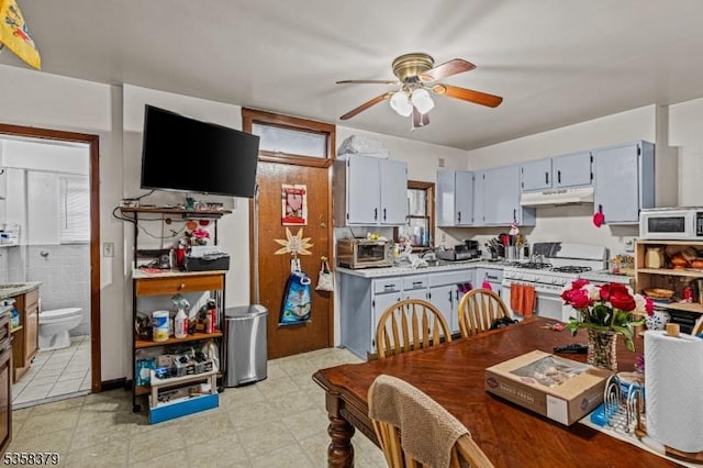 316-318 John St, Elizabeth City, NJ 07202 - kitchen featuring white appliances, under cabinet range hood, ceiling fan, and light countertops