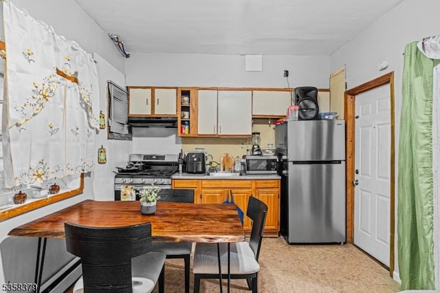 316-318 John St, Elizabeth City, NJ 07202 - kitchen featuring appliances with stainless steel finishes, under cabinet range hood, a sink, light countertops, and white cabinets