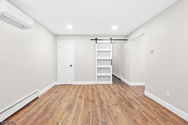 926 Cedar Dr, Stillwater Twp, NJ 07860 - unfurnished bedroom with an AC wall unit, baseboard heating, a barn door, a baseboard radiator, and wood finished floors