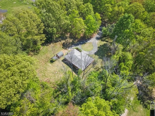 view of subject property with a heavily wooded area