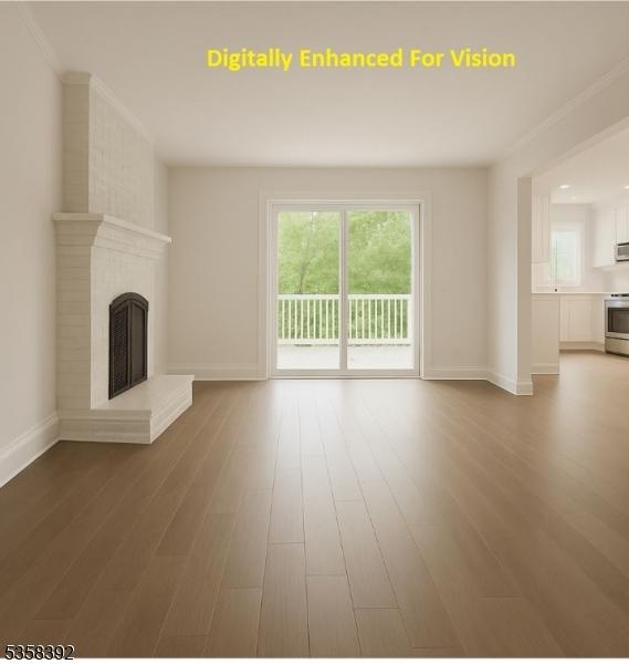 1601 Justin Pl, Mountainside Boro, NJ 07092 - unfurnished living room with wood finished floors, a brick fireplace, baseboards, and crown molding