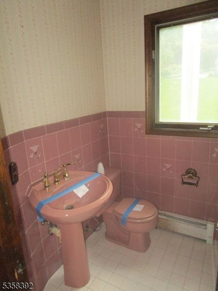 1601 Justin Pl, Mountainside Boro, NJ 07092 - bathroom featuring tile walls, tile patterned flooring, baseboard heating, wainscoting, and toilet