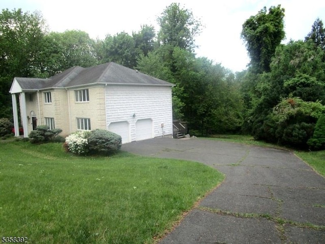 1601 Justin Pl, Mountainside Boro, NJ 07092 - view of property exterior featuring a garage, asphalt driveway, and a yard