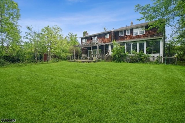 91 Hillcrest Rd, Warren Twp, NJ 07059 - back of property featuring a chimney, a yard, a deck, and a sunroom