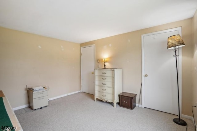 bedroom featuring baseboards and light carpet