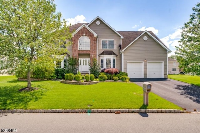 9 Colgate Ct, Franklin Twp, NJ 08873 - view of front of house with driveway, a garage, and a front yard
