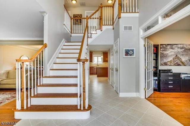 9 Colgate Ct, Franklin Twp, NJ 08873 - stairway featuring a towering ceiling, tile patterned floors, and baseboards