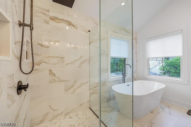 bathroom featuring a freestanding bath, a marble finish shower, marble finish floors, and lofted ceiling