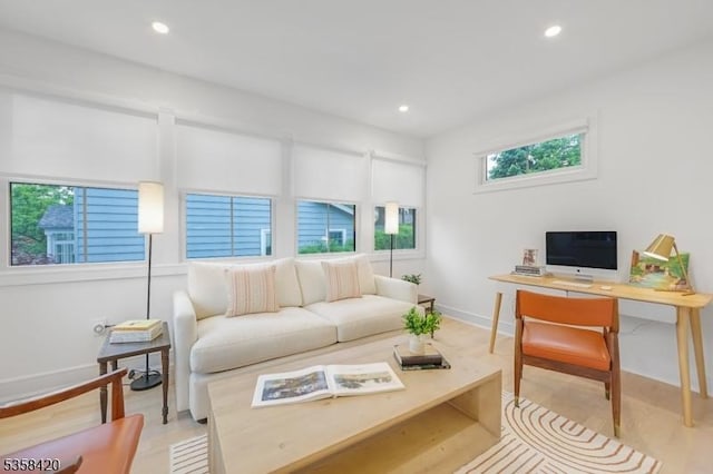 living room with baseboards, recessed lighting, and a desk
