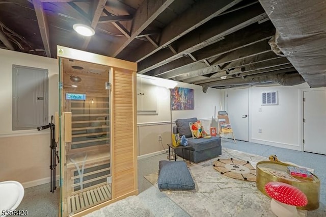 finished basement with baseboards and electric panel