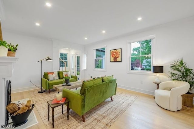 living room with light wood-type flooring, recessed lighting, and baseboards