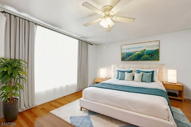 bedroom featuring wood finished floors and a ceiling fan