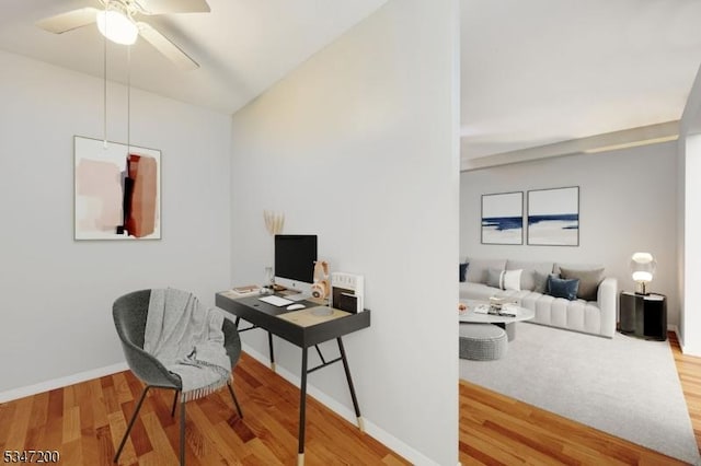 office space with wood finished floors, a ceiling fan, and baseboards
