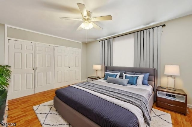 bedroom with wood finished floors, a closet, and a ceiling fan