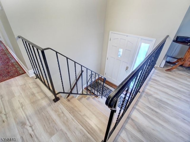 foyer with wood finished floors and baseboards