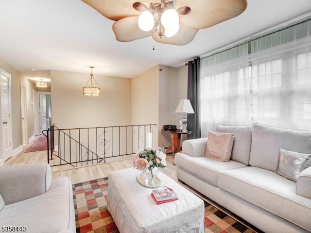 living room with wood finished floors and a ceiling fan