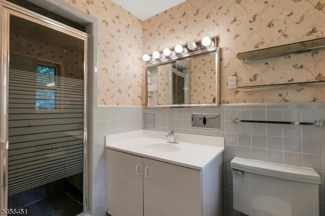 64 Old Smalleytown Rd, Warren Twp, NJ 07059 - full bath with wallpapered walls, wainscoting, vanity, toilet, and tile walls