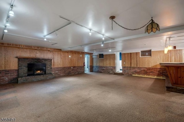 64 Old Smalleytown Rd, Warren Twp, NJ 07059 - unfurnished living room with rail lighting, brick wall, and carpet floors