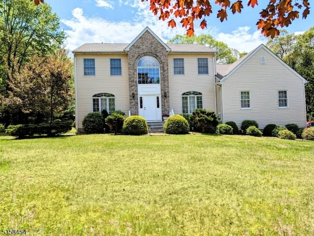 colonial-style house with a front lawn