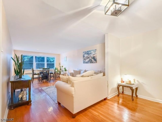 24 Hutton Ave Unit 75, West Orange Twp, NJ 07052 - living area featuring wood finished floors, baseboards, and radiator heating unit