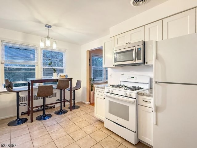 24 Hutton Ave Unit 75, West Orange Twp, NJ 07052 - kitchen with white appliances, white cabinetry, hanging light fixtures, baseboards, and light tile patterned floors