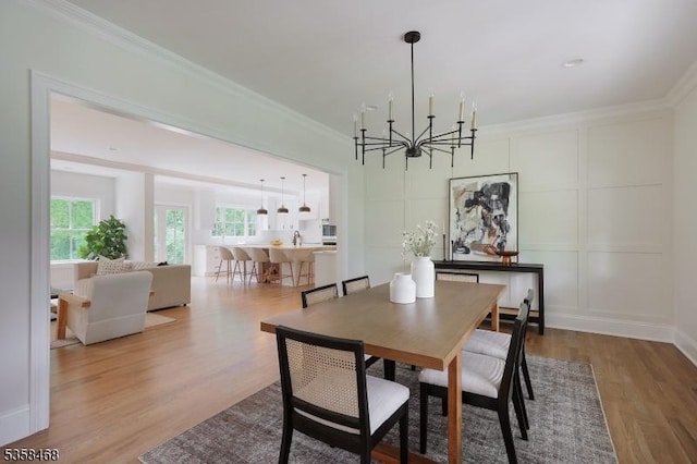 237 Appletree Ln, Mountainside Boro, NJ 07092 - dining area with a chandelier, ornamental molding, wood finished floors, and a decorative wall
