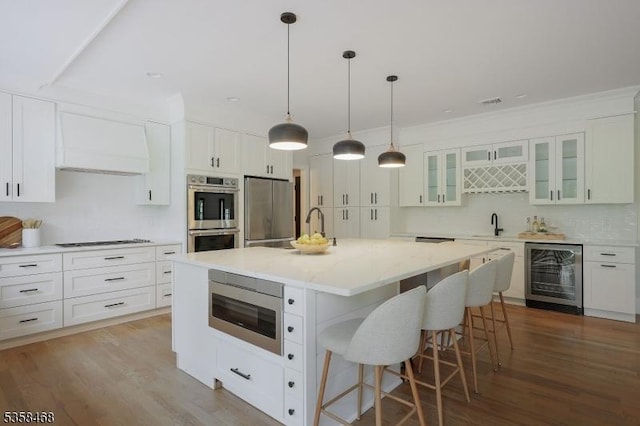 237 Appletree Ln, Mountainside Boro, NJ 07092 - kitchen featuring beverage cooler, stainless steel appliances, tasteful backsplash, a kitchen bar, and white cabinetry